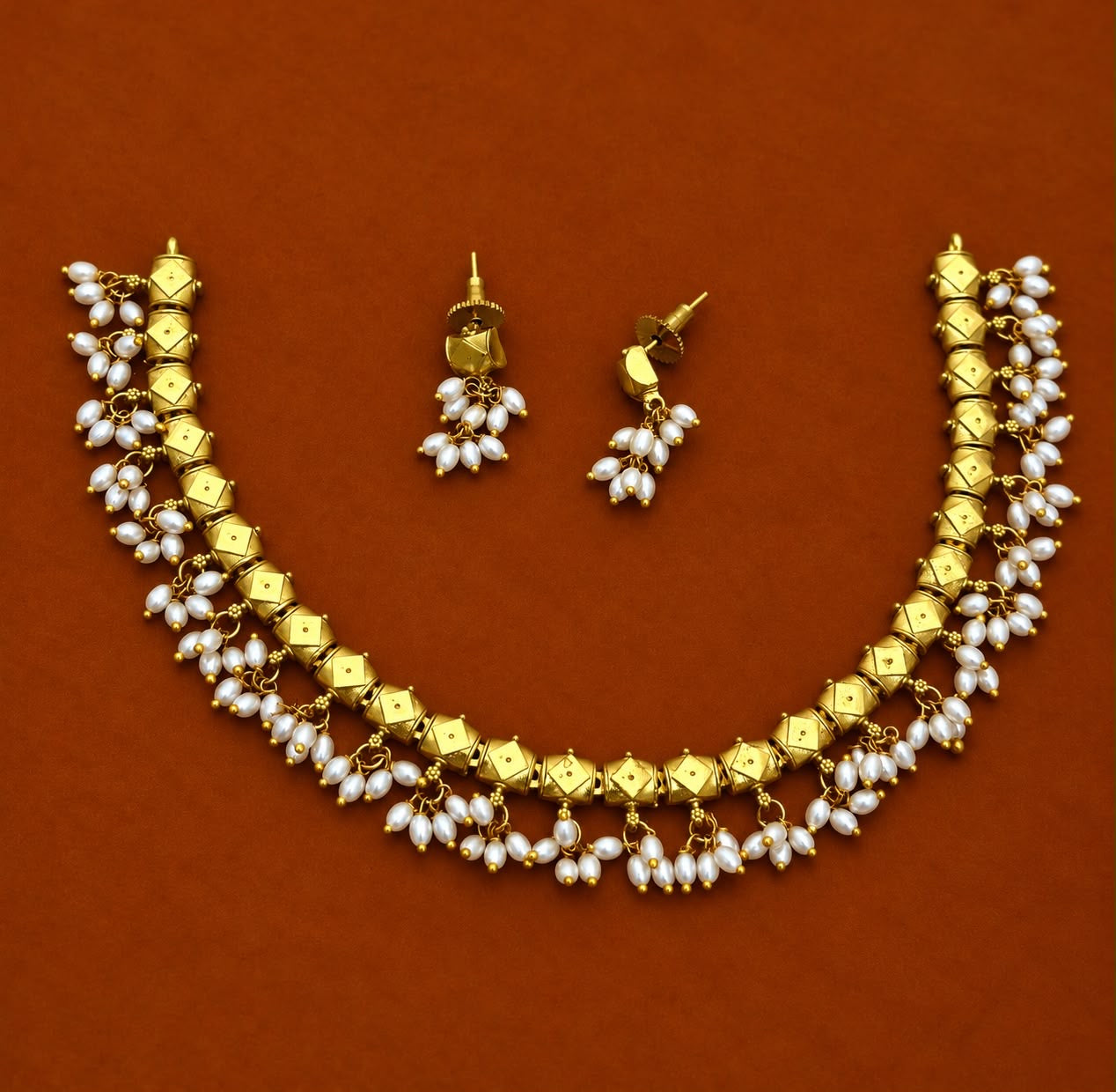 Antique necklace aligned with pearl hanging with earrings